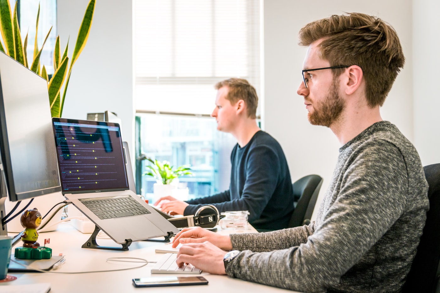 Team reviewing a business workflow on laptops in an office